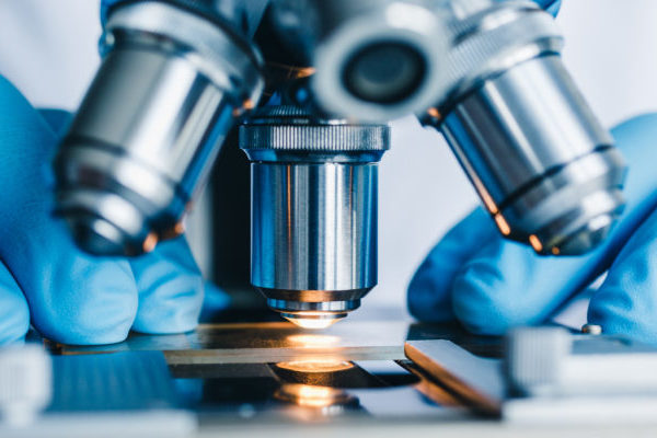 Close-up shot of microscope with metal lens at laboratory.